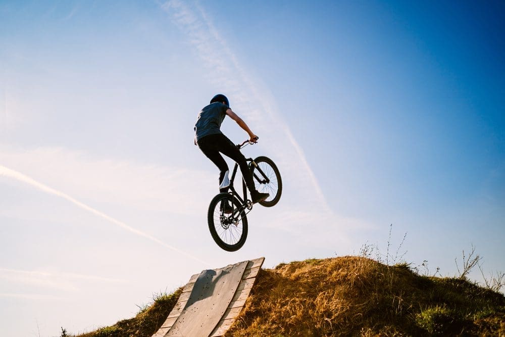 Young,Man,On,A,Mountain,Bike,Performing,A,Dirt,Jump