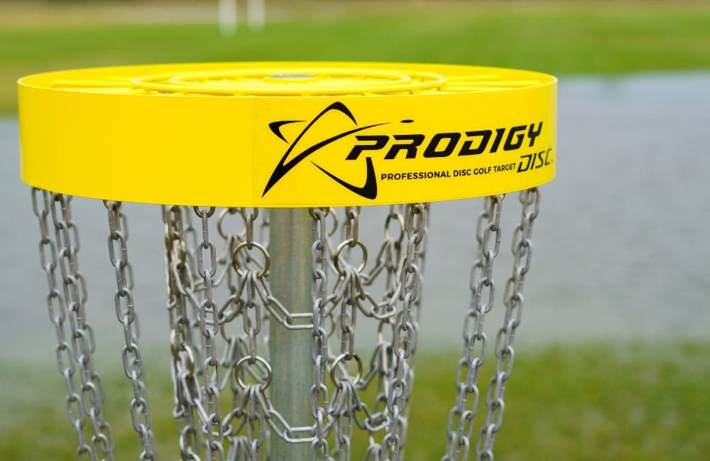A bright yellow disc golf basket with chains