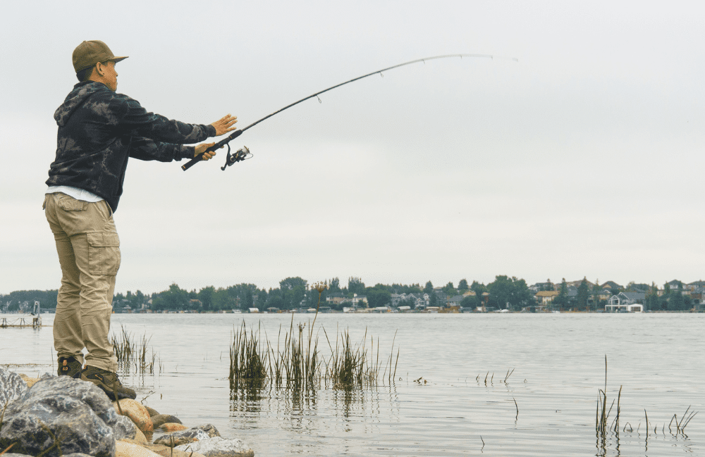 A man casting a fishing line in Chestermere